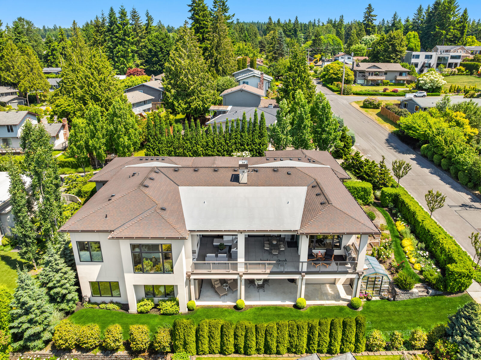 Aerial view of the rear of the home, deck, and greenhouse