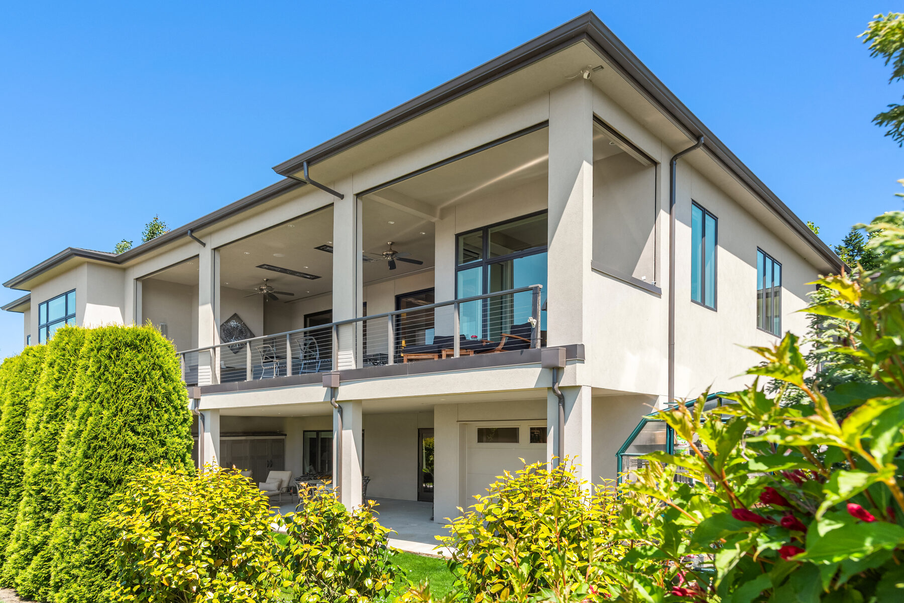 Rear exterior with covered deck and greenhouse